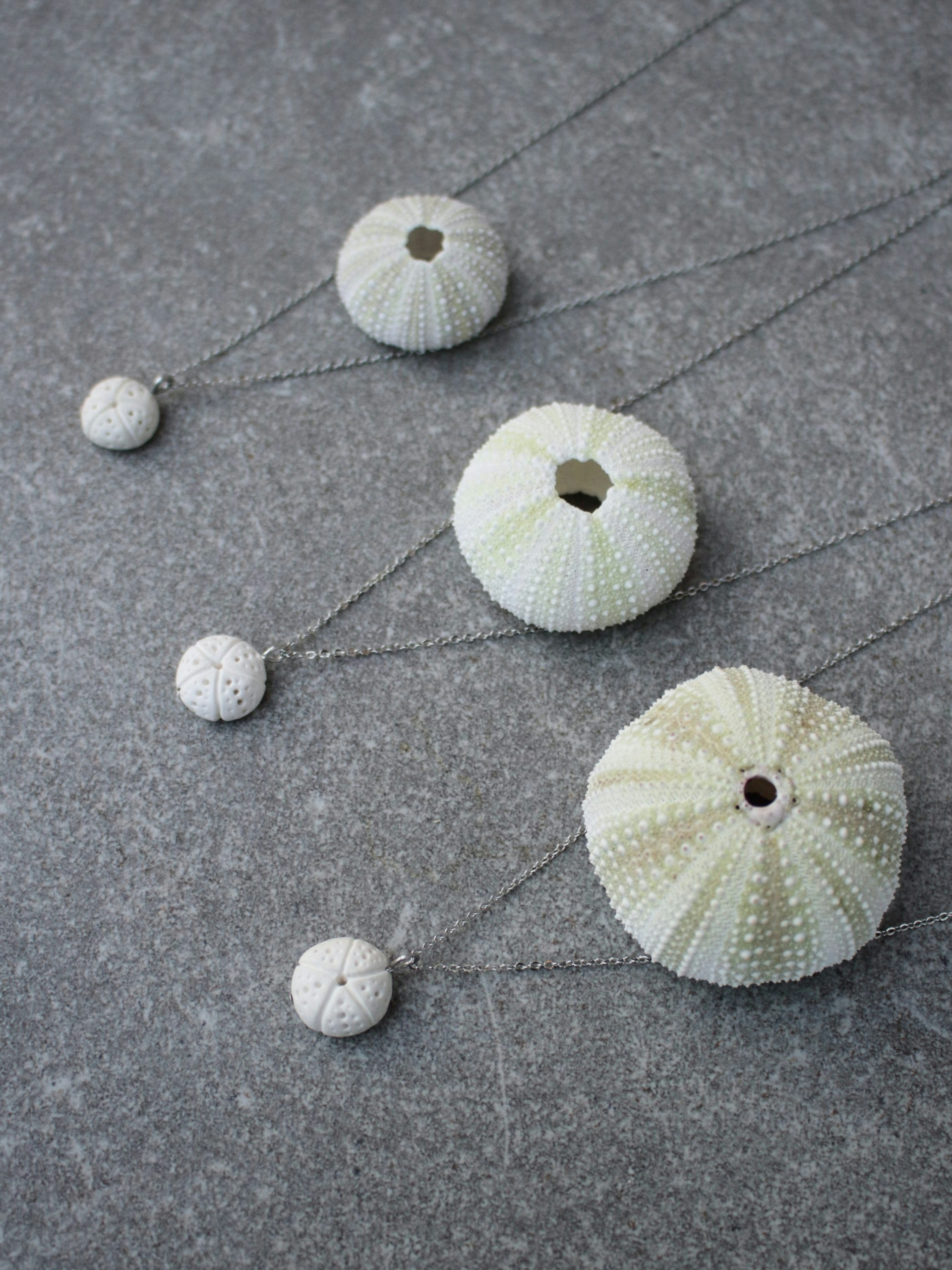 Hand made sea urchin necklaces out of porcelain.